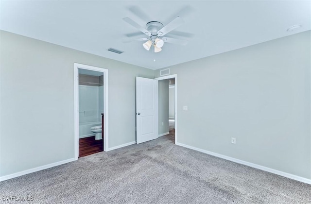 unfurnished bedroom featuring ensuite bath, ceiling fan, and carpet flooring