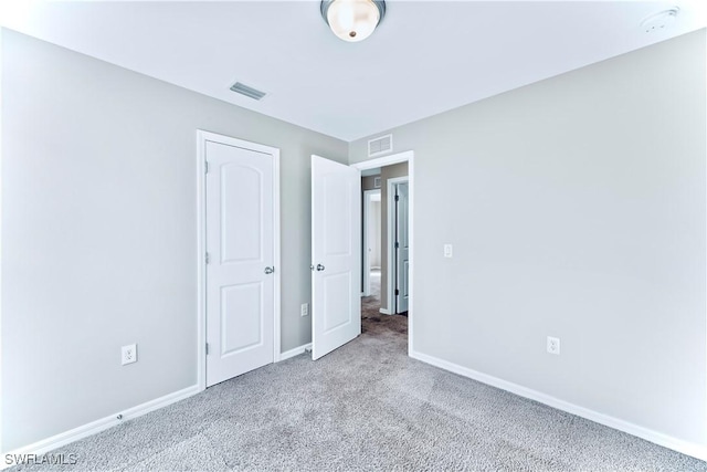 unfurnished bedroom with light colored carpet