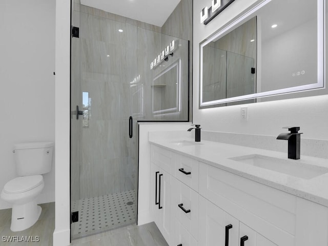 bathroom with walk in shower, vanity, and toilet