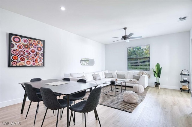 dining area with ceiling fan and light hardwood / wood-style floors