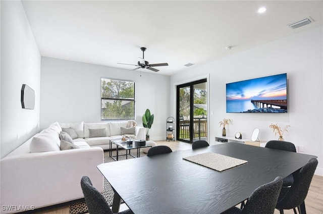 dining area with wood-type flooring and ceiling fan