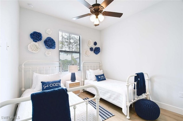 bedroom with hardwood / wood-style floors and ceiling fan