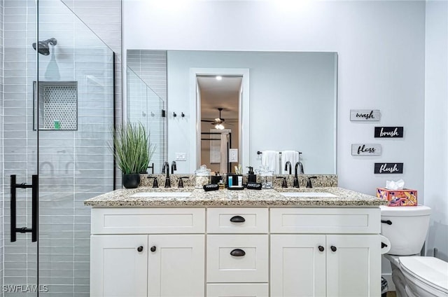 bathroom with vanity, a shower with shower door, and toilet