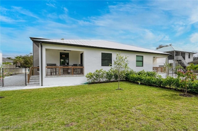 rear view of house with a lawn