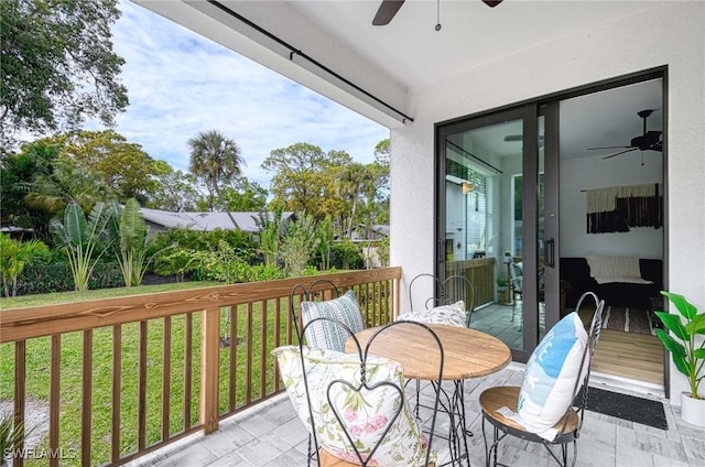 wooden balcony featuring a wooden deck and ceiling fan