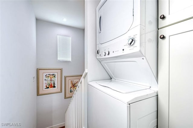 laundry area with stacked washer and clothes dryer