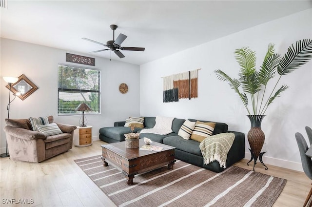 living room featuring ceiling fan and light wood-type flooring