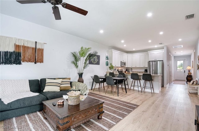 living room with light hardwood / wood-style flooring