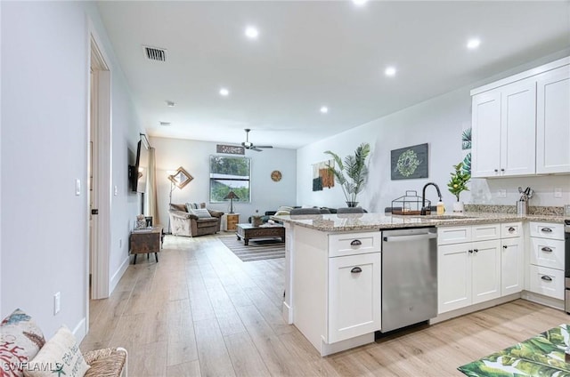 kitchen featuring white cabinets, sink, dishwasher, and light wood-type flooring