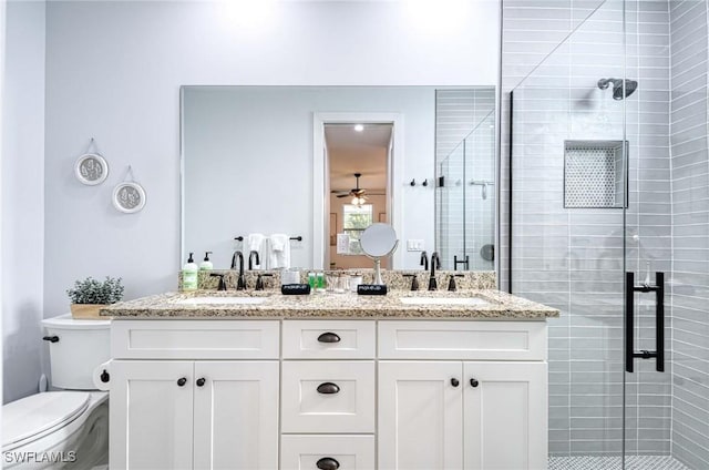 bathroom featuring vanity, toilet, and an enclosed shower