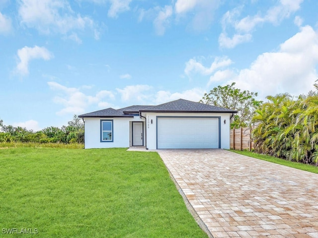 view of front of home with a garage and a front lawn