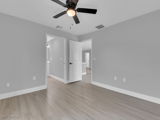 spare room with ceiling fan and light wood-type flooring