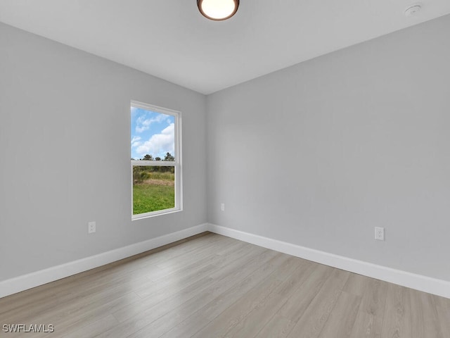 unfurnished room with light wood-type flooring