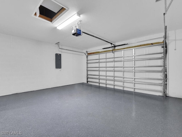 garage with a garage door opener and electric panel