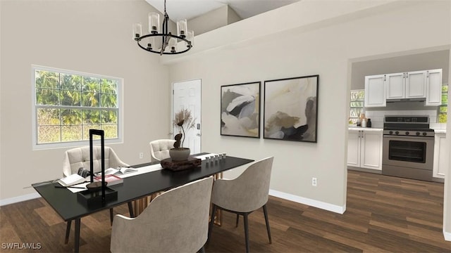 dining space with dark wood-type flooring and a notable chandelier