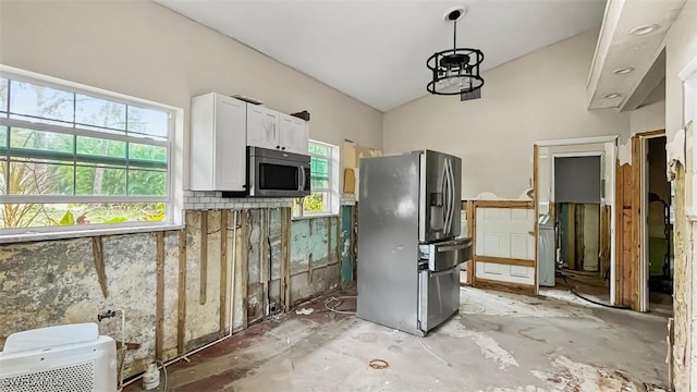 kitchen with stainless steel appliances, white cabinetry, and lofted ceiling