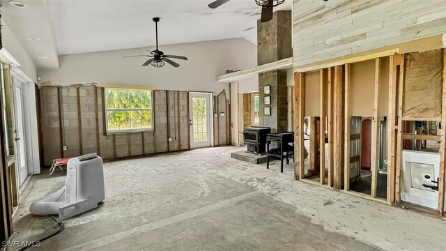 misc room featuring high vaulted ceiling, a wood stove, and ceiling fan