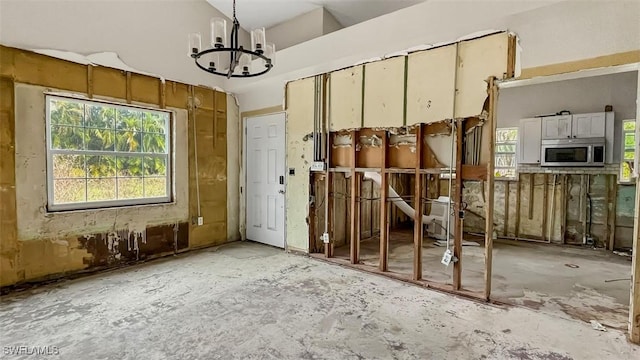 miscellaneous room featuring an inviting chandelier