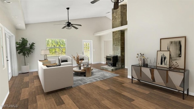 living room with ceiling fan, dark hardwood / wood-style flooring, high vaulted ceiling, and a wood stove