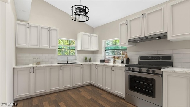 kitchen featuring sink, backsplash, gas stove, and white cabinets