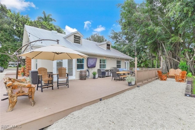 rear view of property featuring a wooden deck