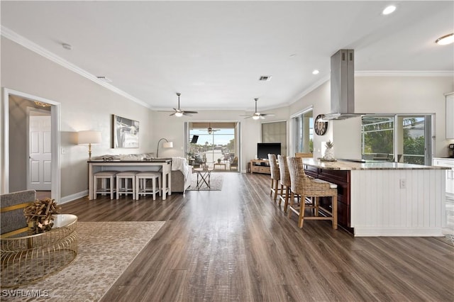 living area with crown molding, visible vents, ceiling fan, baseboards, and dark wood-type flooring