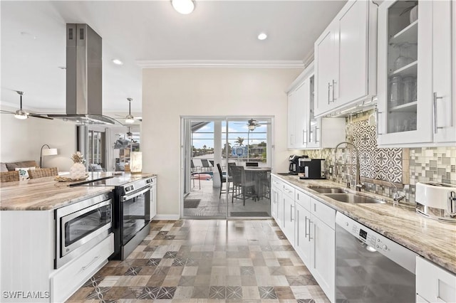 kitchen with sink, white cabinetry, stainless steel appliances, island range hood, and light stone countertops