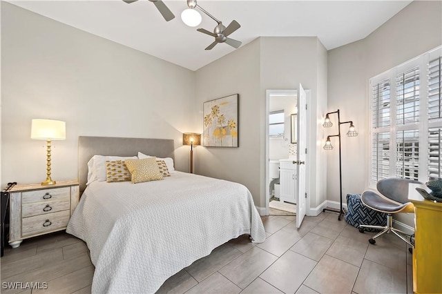 bedroom with baseboards, ceiling fan, and connected bathroom