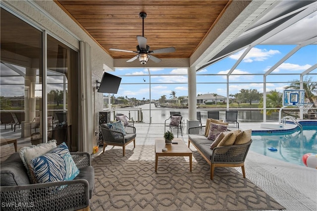 sunroom featuring an outdoor hangout area, ceiling fan, and a swimming pool