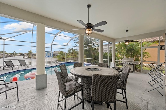 view of patio featuring an outdoor pool, grilling area, glass enclosure, and outdoor dining area