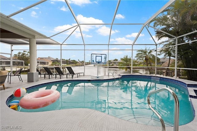 view of pool featuring a lanai, a patio area, and a water view