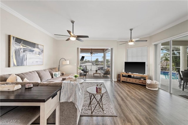 living room featuring a wealth of natural light, ceiling fan, and crown molding