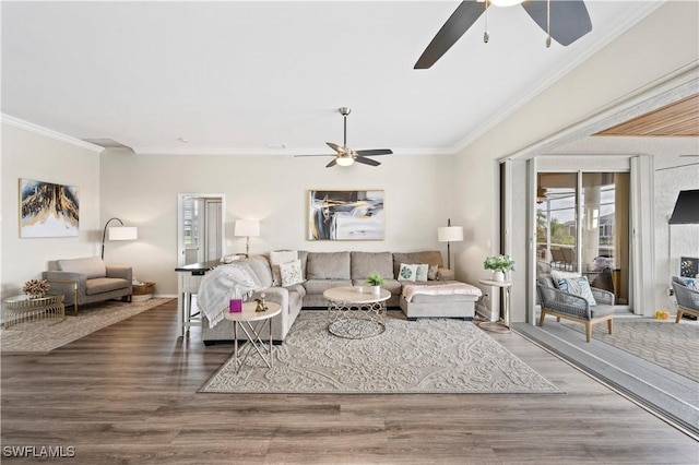 living room with wood finished floors, a ceiling fan, and crown molding