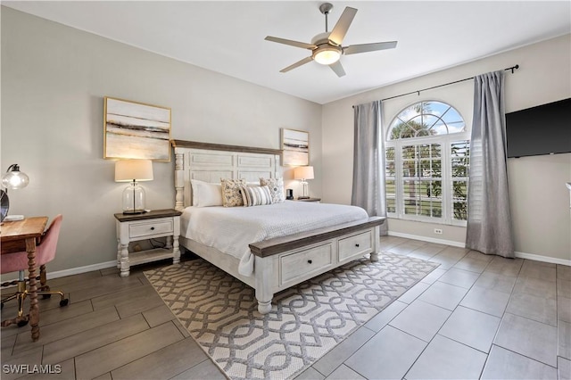 bedroom with a ceiling fan and baseboards