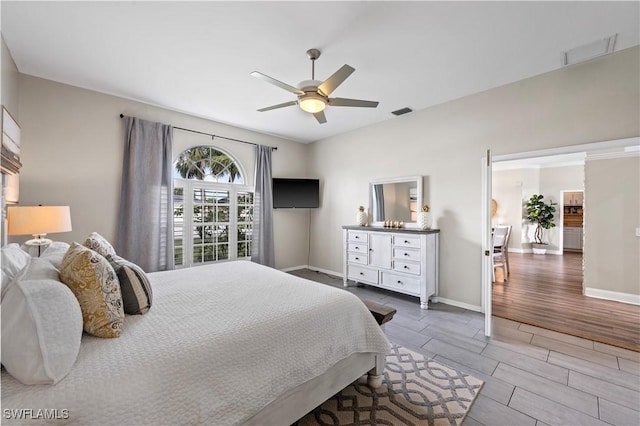 bedroom with visible vents, wood finish floors, and baseboards
