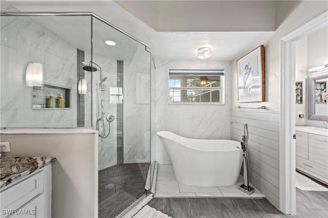 bathroom featuring vanity and shower with separate bathtub