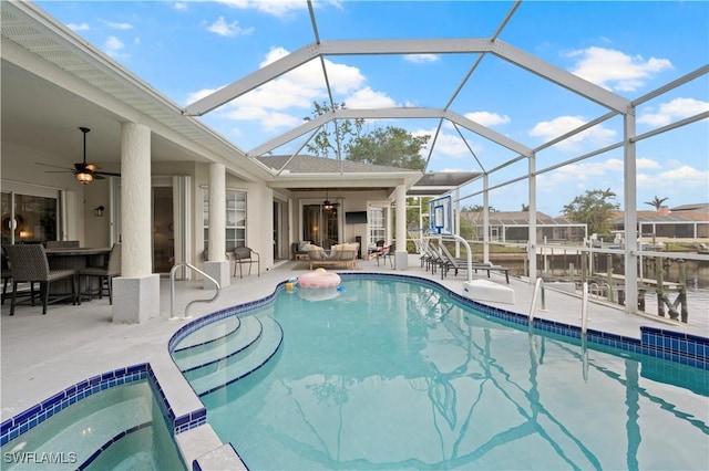 pool featuring an outdoor living space, ceiling fan, a hot tub, a patio, and a lanai