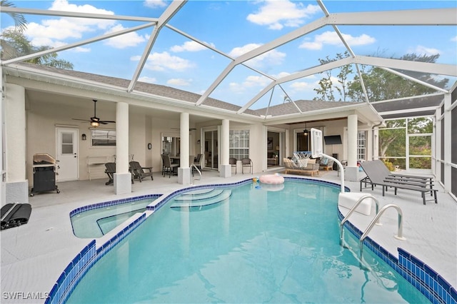 view of swimming pool featuring ceiling fan, a patio area, and glass enclosure