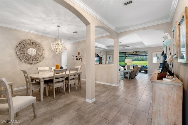 dining room featuring crown molding, light hardwood / wood-style floors, and ceiling fan with notable chandelier