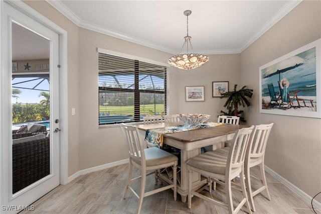 dining room with ornamental molding and light hardwood / wood-style floors