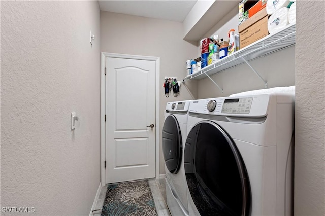 clothes washing area with washing machine and dryer