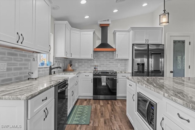 kitchen with custom exhaust hood, white cabinets, and appliances with stainless steel finishes