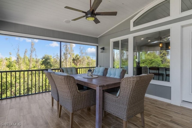 sunroom featuring lofted ceiling and ceiling fan