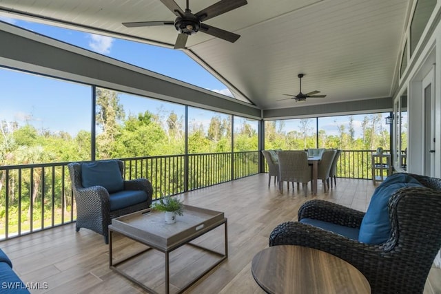 sunroom featuring lofted ceiling and ceiling fan