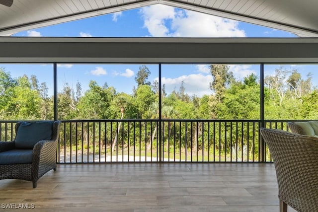 sunroom / solarium featuring vaulted ceiling