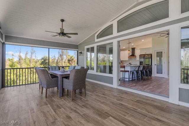 sunroom / solarium with vaulted ceiling and ceiling fan