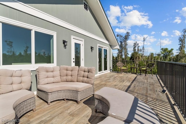 wooden terrace featuring an outdoor living space