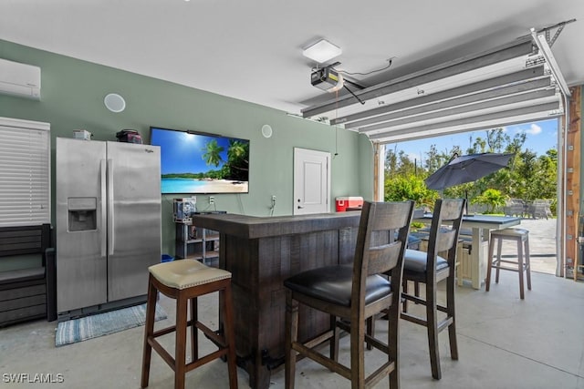 bar with stainless steel fridge, concrete floors, and an AC wall unit