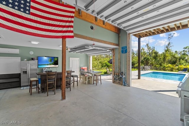 view of patio with exterior kitchen, exterior bar, and a wall unit AC