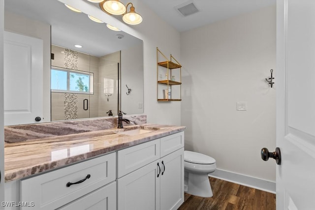 bathroom with walk in shower, vanity, toilet, and wood-type flooring